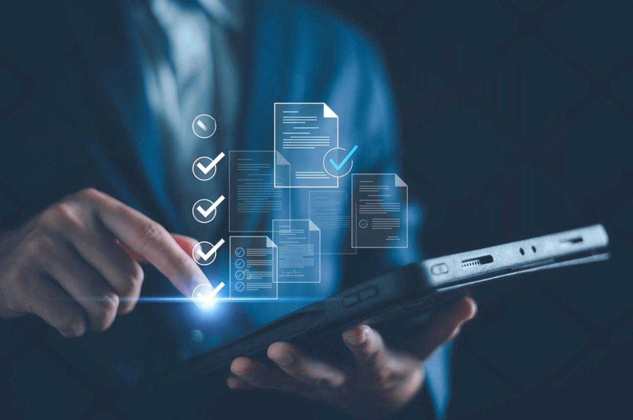 Questions to Ask Before Hiring an IT Outsourcing Provider in NYC – Managed IT Services, Consulting, and Support for Businesses and Non Profits Business professional using tablet with digital checklists and documents, symbolizing questions to ask when hiring an IT outsourcing provider in NYC.